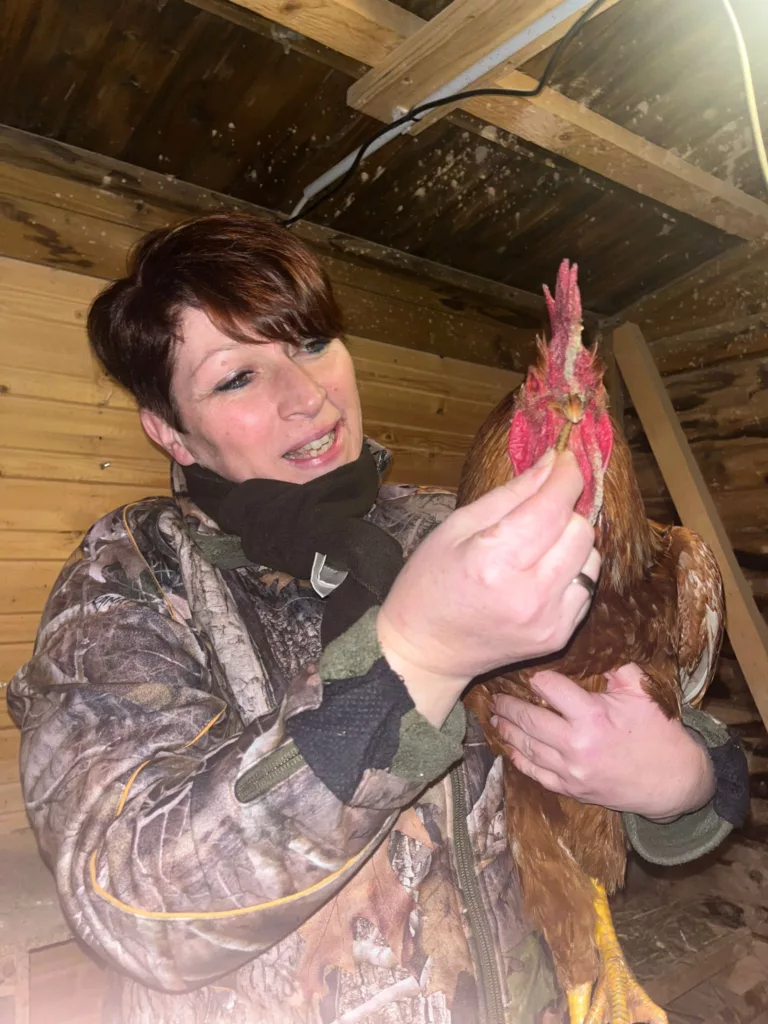 Marleen Porkert untersucht ein Huhn im Stall